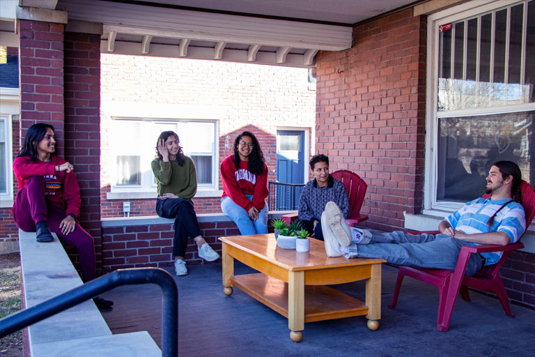 Students gather to socialize on FNECC covered front porch.